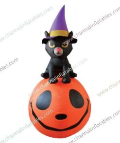 inflatable black cat with witch hat on pumpkin