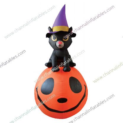 inflatable black cat with witch hat on pumpkin