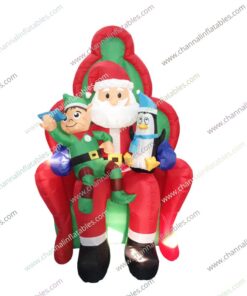 inflatable Santa sitting with penguin and elf