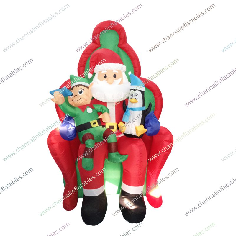 inflatable Santa sitting with penguin and elf