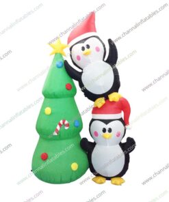 inflatable duo penguins next to Christmas tree