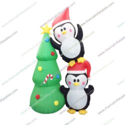 inflatable duo penguins next to Christmas tree
