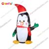 inflatable penguin with Santa hat and green mitten