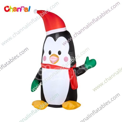 inflatable penguin with Santa hat and green mitten